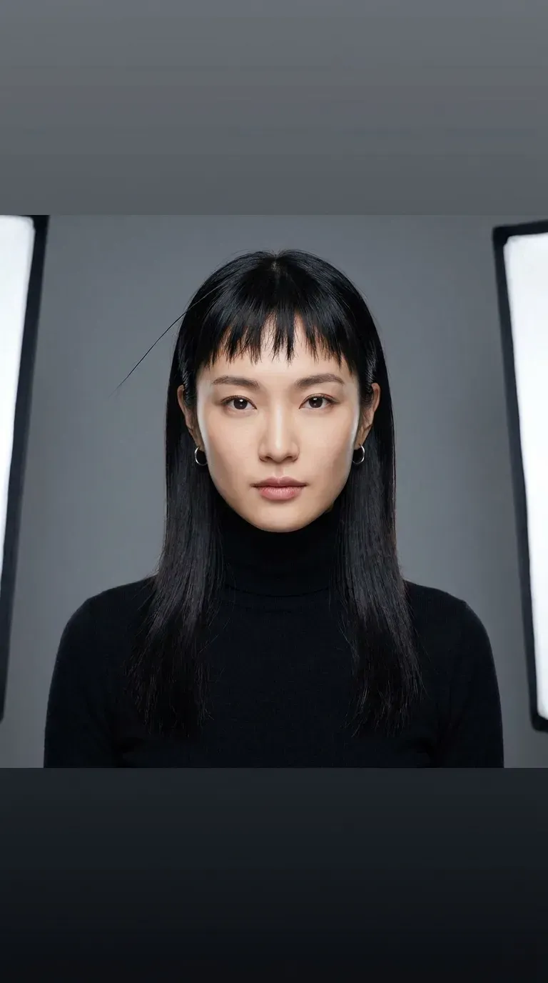 Woman with sleek straight hair and choppy textured bangs